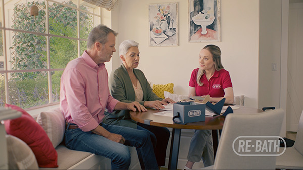 Family at table with re-bath employee